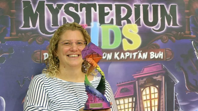 Mysterium Kids designer with trophy at Essen Spiel 2023