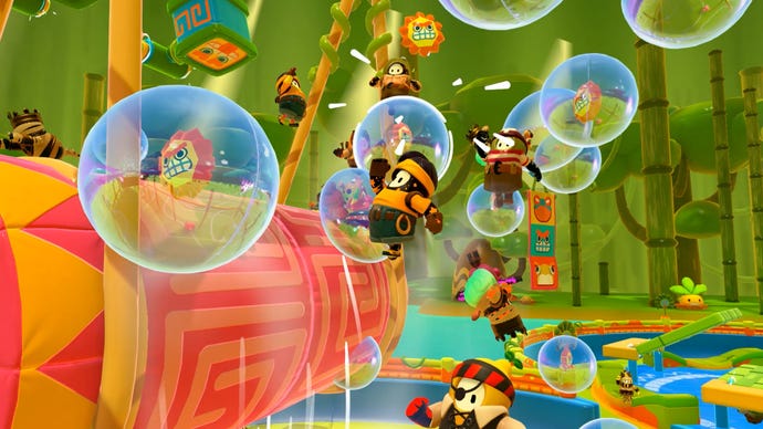 Fall Guys season 5 image - Several Fall Guys leap through the air towards bubbles with small lion head symbols in them.