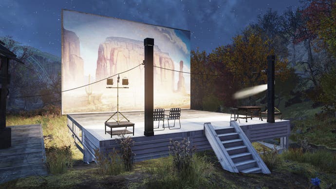 A large painted backdrop lit by floodlights at twilight. It's an open-air photography studio in Fallout 76.