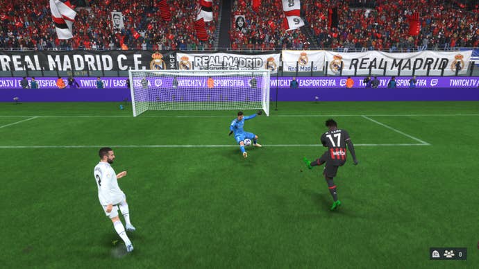 Thibaut Courtois smothering a shot from Rafael Leao in FIFA 23