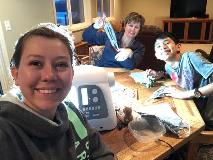 Briena crafting masks with her family.