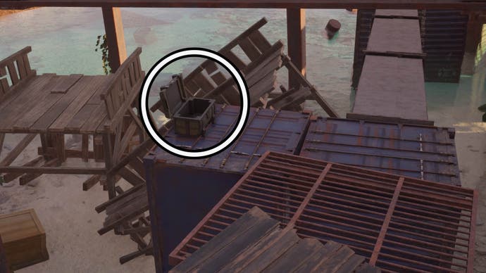 A circle highlights an open reward chest sitting on top of a blue container.