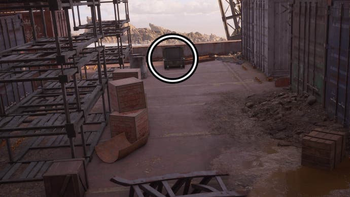 A circle highlights an open reward chest on the deck of an abandoned ship, next to old metal shelves and large shipping containers.