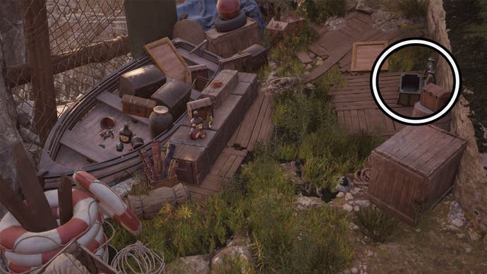 A circle highlights an open reward chest on the right side of the screen, it is among some abandoned treasure and in front of a wooden rowboat filled with items.