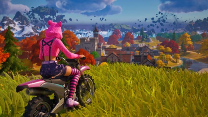 Fortnite, official Epic Games image of a character sat on a hill on a motorbike overlooking another area of the map.