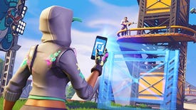 A Fortnite character uses their phone to edit a tower another character is standing on.