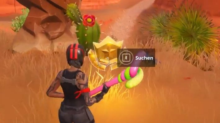 Fortnite Suche zwischen einer Oase, einem Felsbogen und Dinosauriern