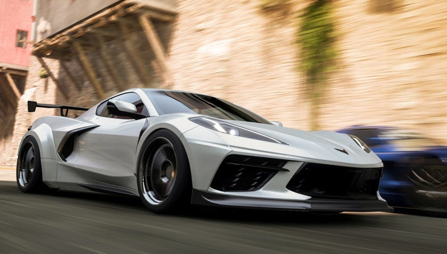 A screenshot of Forza Horizon 5 showing a grey sports car driving fast against a blurred background.
