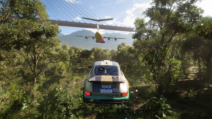 In Forza Horizon 5, a car catches air while following a low-flying plane through a jungle.