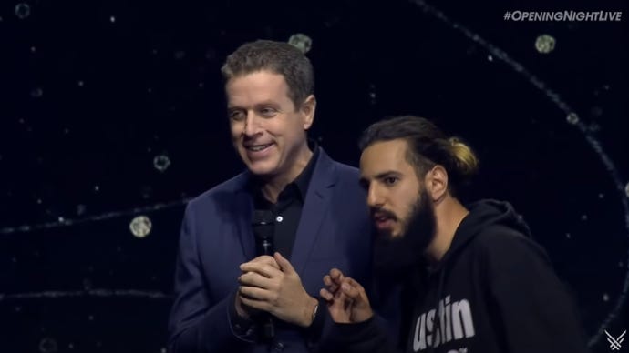 Game Awards host Geoff Keighley alongside a stage crasher.