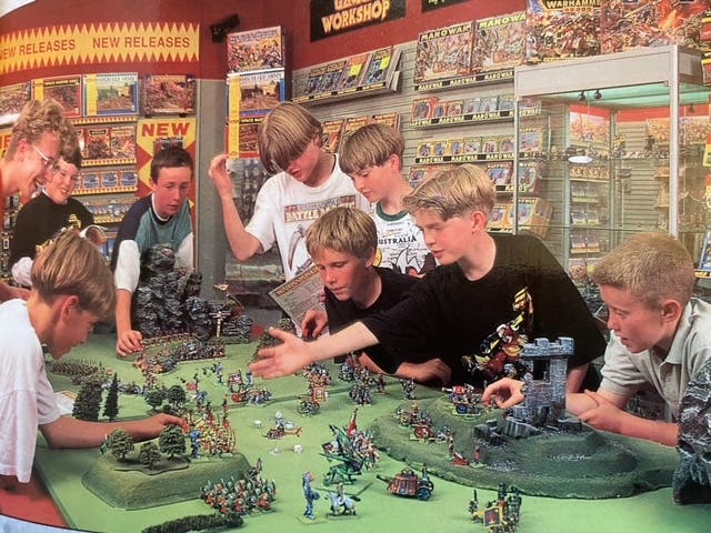 A photograph from a Games Workshop magazine from 1994. There are a lot of blonde, white boys, all with the same haircut.