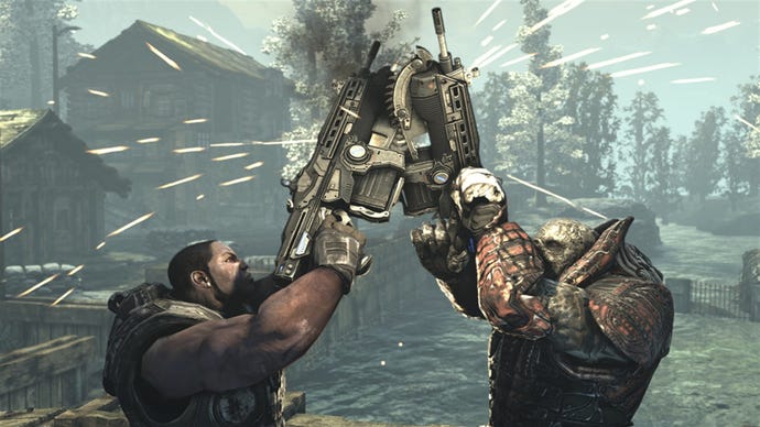 A man and a monster clash chainsaw guns in Gears Of War 2
