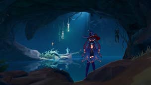 Genshin Impact Kory Drum locations: An anime woman with black hair in pigtails, wearing a sparkling blue romper and floppy hat, is standing in a cave. In front of her is a dimly lit pond with green lights flickering in a stone lantern