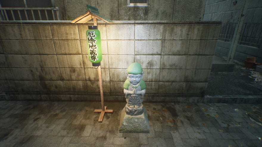 A wind Jizo statue beneath a lantern in Ghostwire: Tokyo.