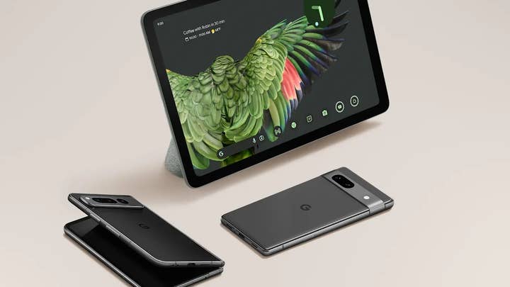 A Google Pixel 7a, Pixel Fold, and Pixel tablet set up against an off-white background