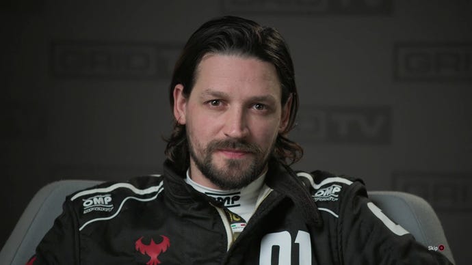 A male racing driver in a black racing garb with a very smug look on his face in Grid Legends