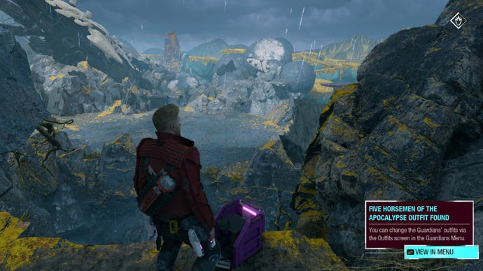 Star-Lord opening an outfit box on a cliff with Seknarf Nine in the background