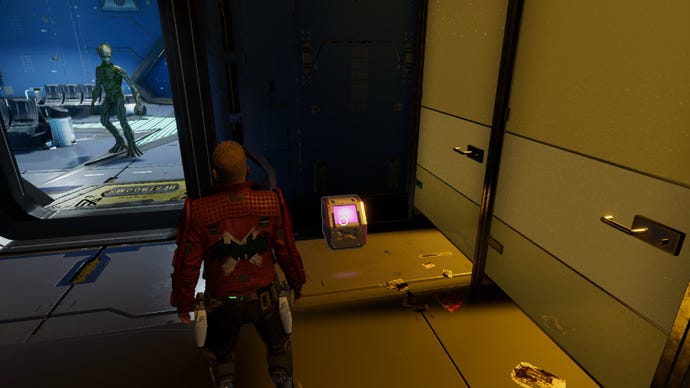 Star-Lord stood by outfit box with Groot staring through door at him