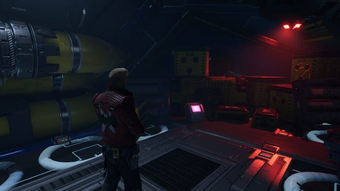 Star-Lord handcuffed staring at outfit box by yellow crates