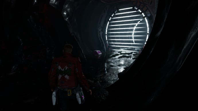Star-Lord in a dark tunnel staring at outfit box by lasers