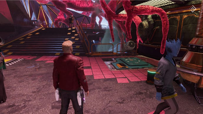 Star-Lord stands near alien at a market stall, stairway up ahead leads to pink plant