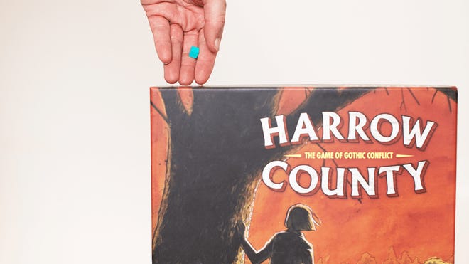 An image of blocks being putt into the box for Harrow County: A Game of Gothic Conflict