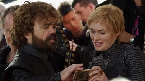 Game of Thrones actors looking at cell phone