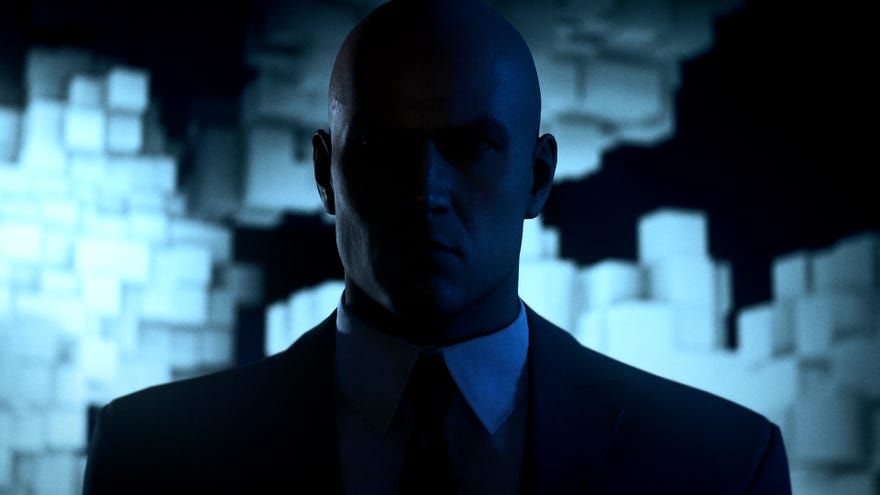 Ian Hitman stands shadowed in a Hitman 3 screenshot.
