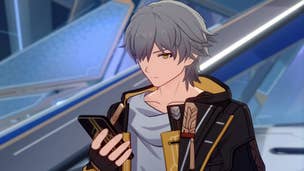 Honkai Star Rail Trailblazer build: An anime man with short, silver hair, wearing a white shirt with a floppy collar and a gold-and-brown jacket with tassels, is standing in a metal hallway. He holds a phone in his right hand and is looking down at it.