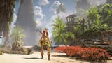 A Horizon Forbidden West screenshot showing Aloy stood on a tropical beach with crumbling skyscrapers towering behind her.