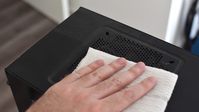An image of a PC case being cleaned of dust.
