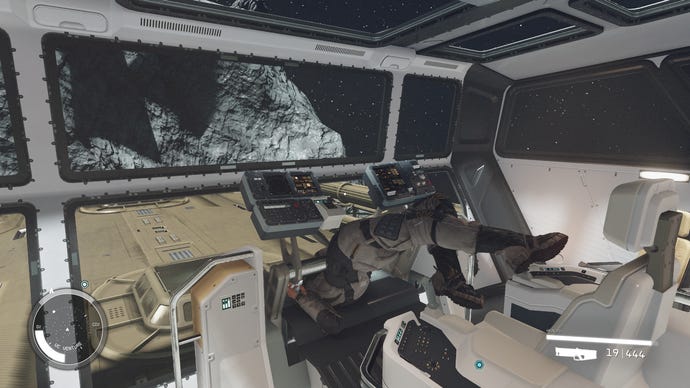 A dead spaceship pilot lodged upside down against the steering controls in Starfield.