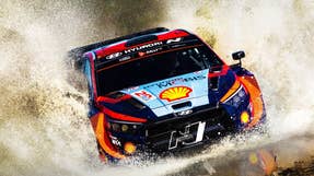 hyundai i20 n rally car emerging from a massive water splash