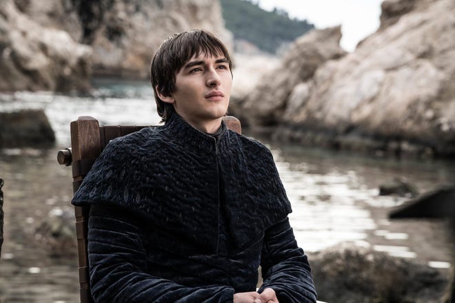 Promotional still of Bran sitting in his chair with a river in the back