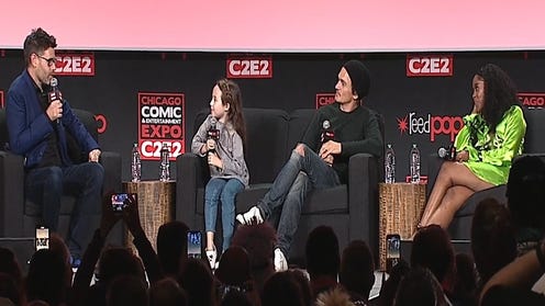 The Inquisitors panel at C2E2 on the stage holding mics
