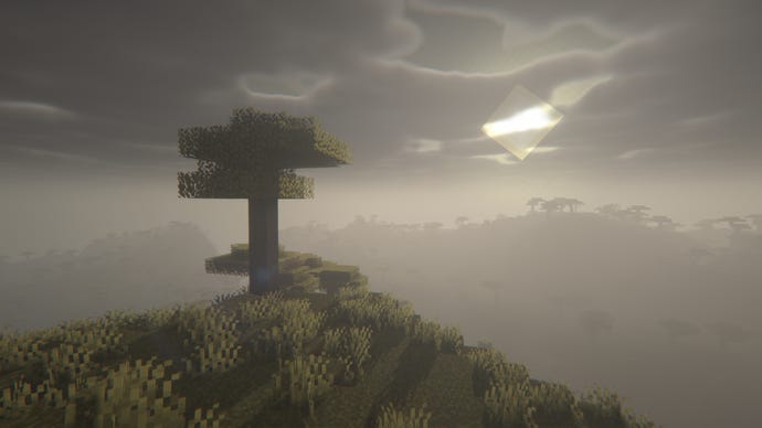 A foggy Minecraft landscape with a single tree in the foreground.