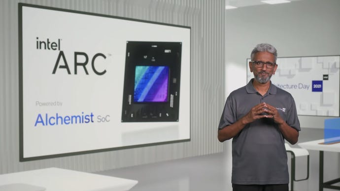 Intel executive Raja Koduri standing next to a presentation on Intel Arc GPUs.