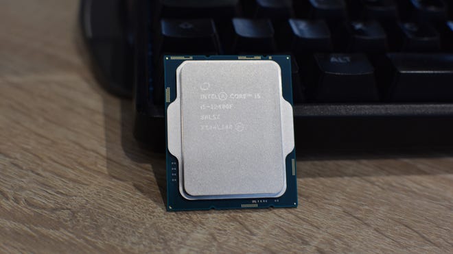 An Intel Core i5-12400F CPU resting against a gaming keyboard.