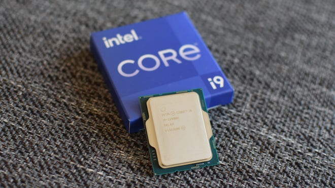 An Intel Core i9-12900K CPU next to its packaging box.