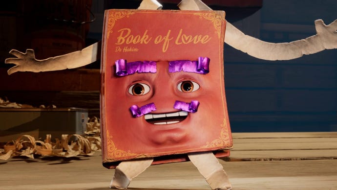 Hakim the Book Of Love from It Takes Two, a read leatherbound book with arms and legs made of strips of paper. Hakim has human eyes and teeth and eyebrows and a moustache made from bright purple strips of paper or fabric.