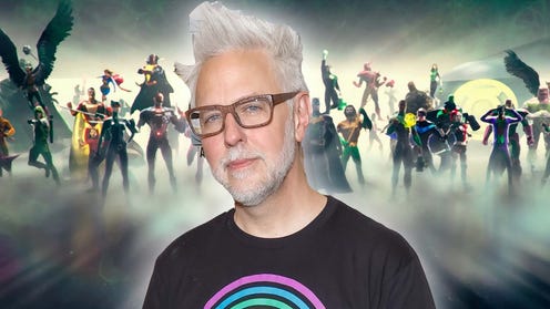 Image featuring James Gunn wearing glasses and a black tshirt with DC heroes in the background