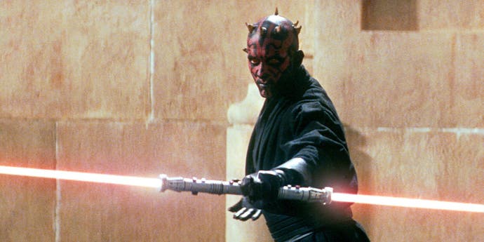 A still from Episode 1: The Phantom Menace of Darth Maul holding his iconic double-bladed lightsaber