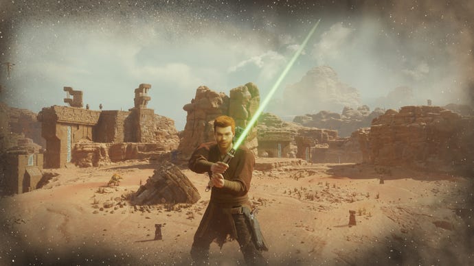 Cal raises his green single-blade lightsaber towards the camera in Star Wars Jedi: Survivor.