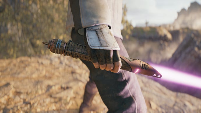 A close-up screenshot of a magenta-bladed lightsaber in Cal's hand in Jedi: Survivor.