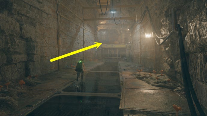 A cave passage on Koboh in Jedi: Survivor, with an arrow pointing in the direction of Vashtan Wolfe's Lair.