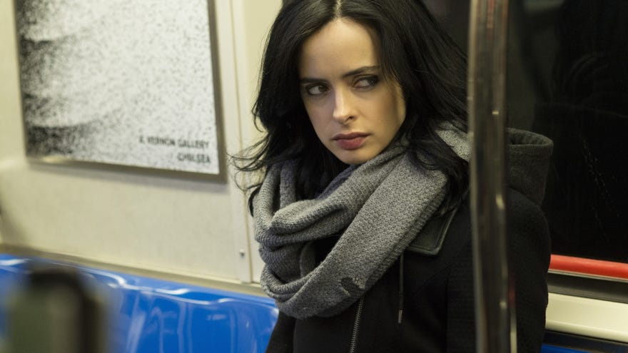 Kristen Ritter as Jessica Jones sitting in a subway
