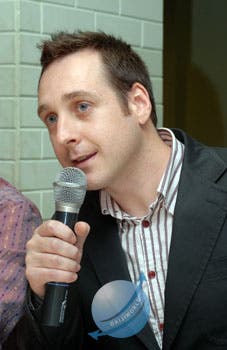 A photo portrait of Keith Pullin, speaking into a mic