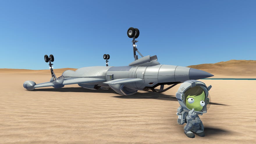A bemused Kerbal stands in front of an upside-down plane crashed on a desert planet in Kerbal Space Program 2.