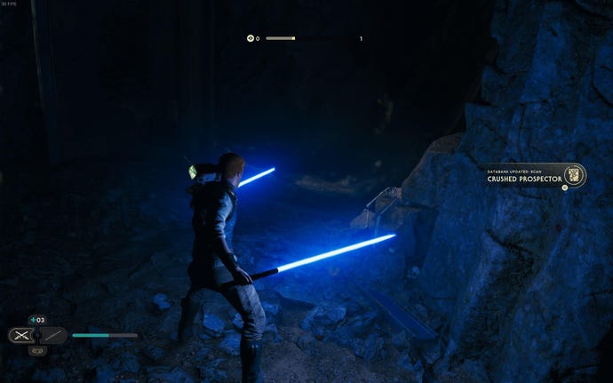 Cal holds two dual lightsabers in the darkness of a cave while BD-1 scans a crushed prospector for a databank entry.