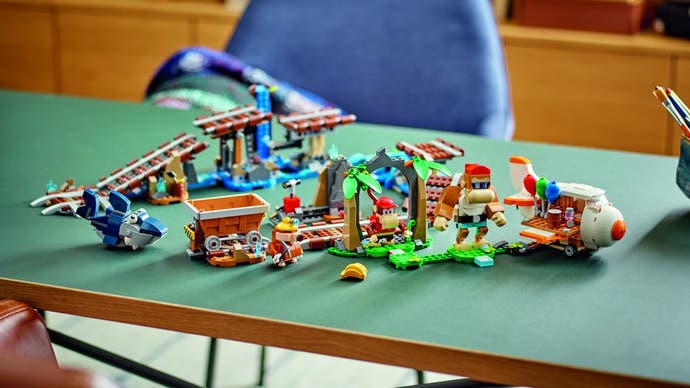 Lego Diddy Kong's Mine Cart Ride set as a jumble of track pieces and parts spills out onto a table.